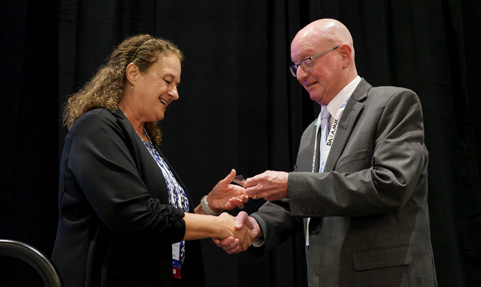 Battery industry female receiving her Quarter-Century Club pin at the BCI Convention.
