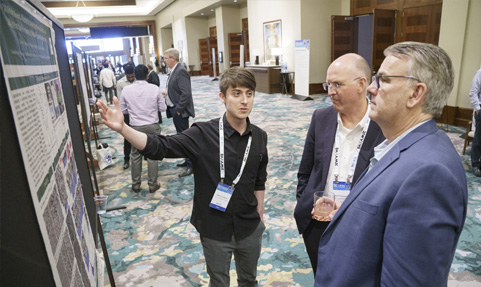 BCI Convention Battery Research Poster Showcase entrant explaining his research to attendees.